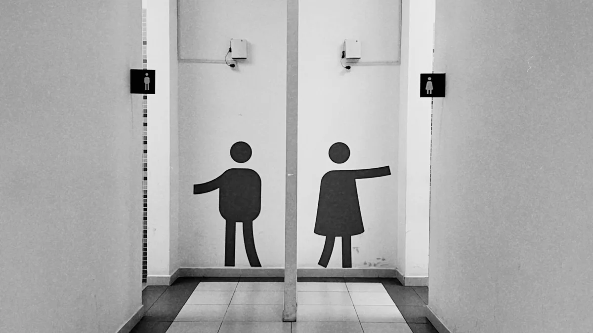 Minimalistischer schwarz-weißer Flur mit Toilettenschildern im öffentlichen Gebäude von Almaty.
